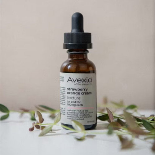 Avexia strawberry orange cream tincture with 1:1 CBD:THC ratio in amber dropper bottle, available at Midnight Greens Dispensary.